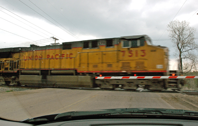 Photo of train going rail crossing.